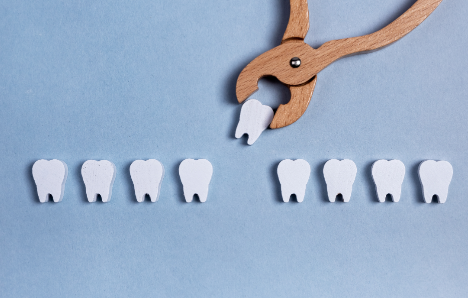 Wooden forceps picking up wooden toy tooth